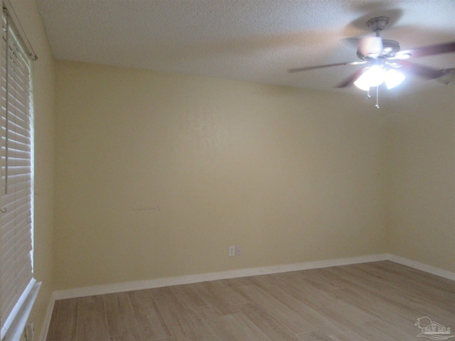 5078 Babb Ln, Pace, FL 32571 - empty room with light wood-style floors, ceiling fan, and a textured ceiling