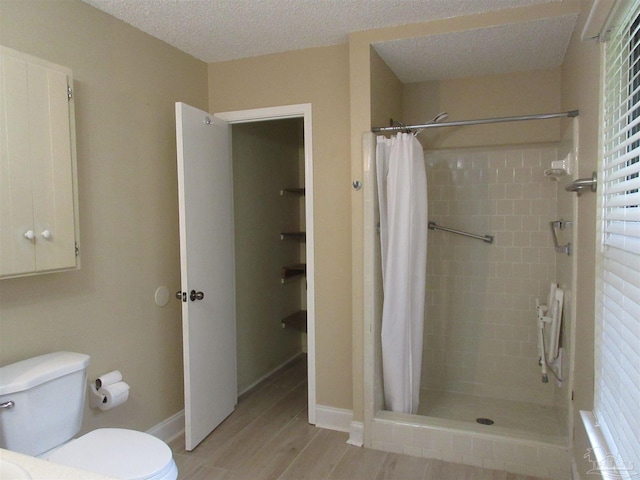 5078 Babb Ln, Pace, FL 32571 - bathroom featuring a stall shower, wood finished floors, and a textured ceiling
