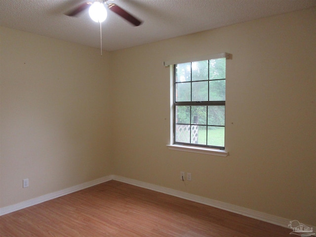 5078 Babb Ln, Pace, FL 32571 - unfurnished room with light wood finished floors, ceiling fan, and a textured ceiling