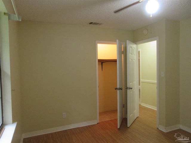 5078 Babb Ln, Pace, FL 32571 - unfurnished bedroom featuring light wood-style flooring and a textured ceiling