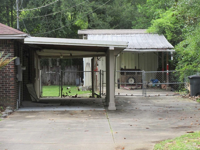 5078 Babb Ln, Pace, FL 32571 - exterior space featuring a gate, concrete driveway, and an attached carport