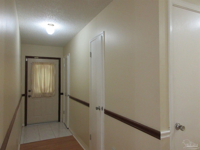 5078 Babb Ln, Pace, FL 32571 - hallway featuring a textured ceiling and light tile patterned flooring