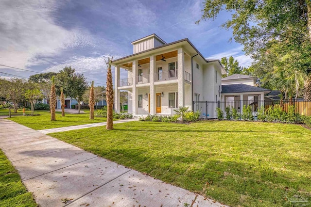 view of front facade featuring a balcony and a front lawn