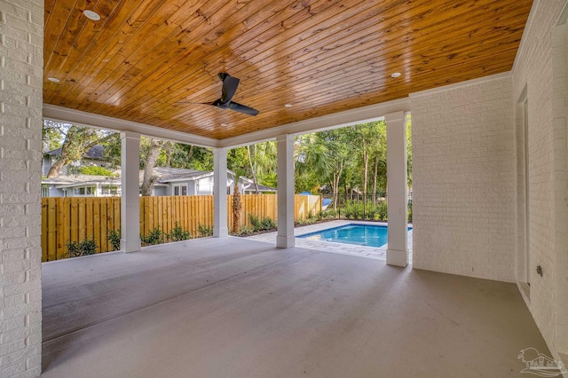 view of patio / terrace with a fenced in pool and ceiling fan