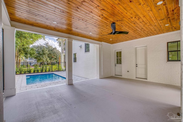 view of patio / terrace with a fenced in pool and ceiling fan