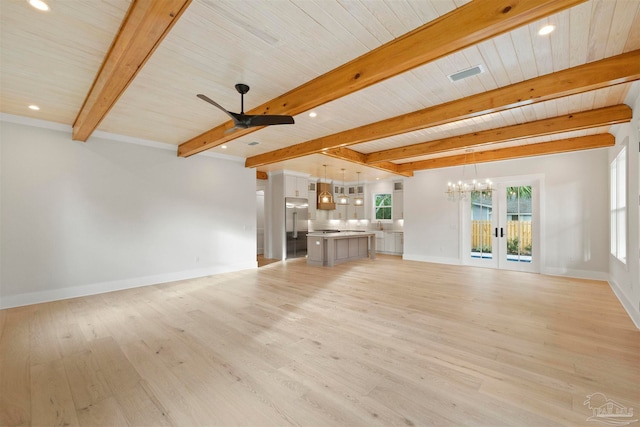 unfurnished living room with beam ceiling, ceiling fan with notable chandelier, light wood-type flooring, and french doors