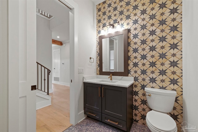 bathroom featuring vanity, toilet, and wood-type flooring