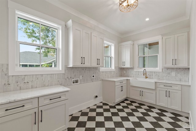 washroom featuring sink, crown molding, cabinets, hookup for a washing machine, and electric dryer hookup