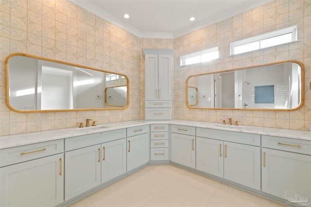 bathroom featuring vanity, tile patterned flooring, crown molding, and backsplash