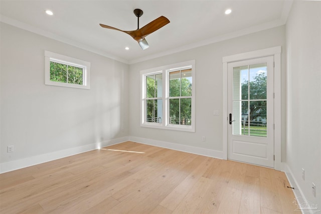 unfurnished room with light hardwood / wood-style flooring, crown molding, a wealth of natural light, and ceiling fan