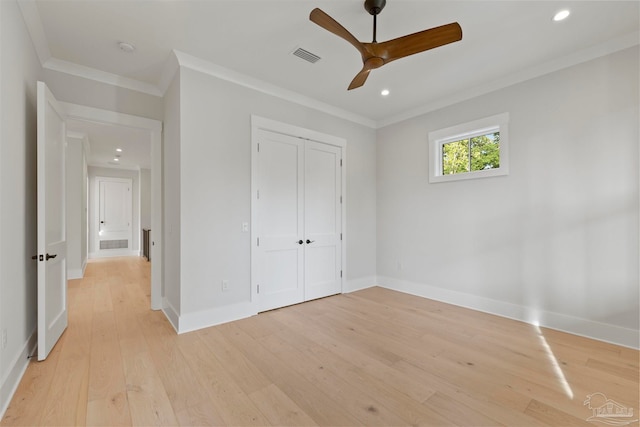 unfurnished bedroom featuring crown molding, a closet, ceiling fan, and light hardwood / wood-style floors