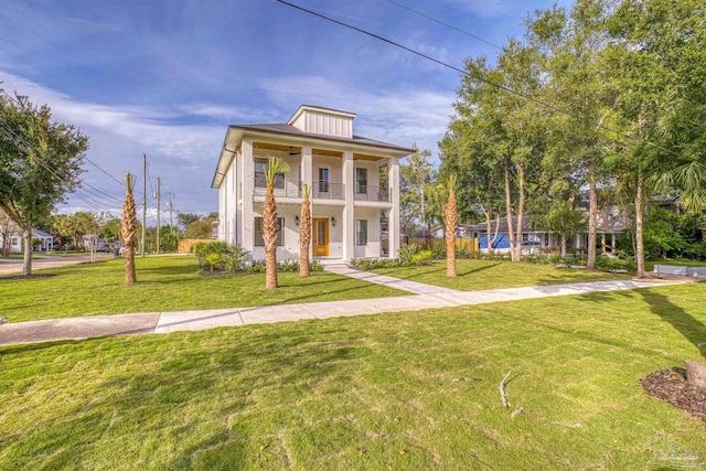 view of front of house with a balcony and a front yard