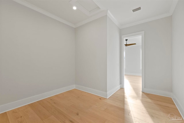 unfurnished room with ornamental molding and light wood-type flooring