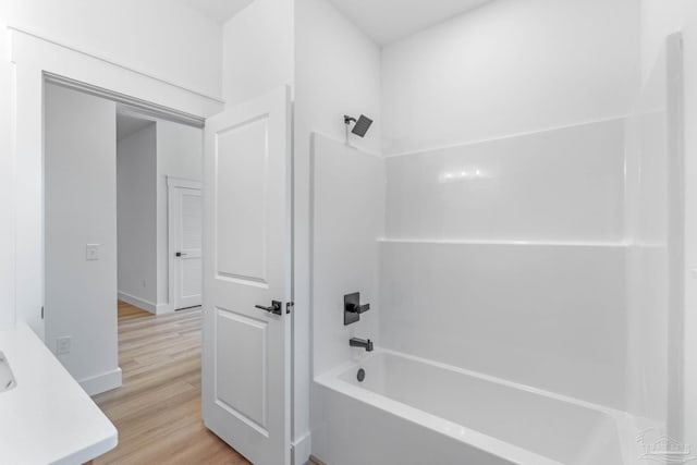 bathroom featuring vanity, wood-type flooring, and shower / bathtub combination