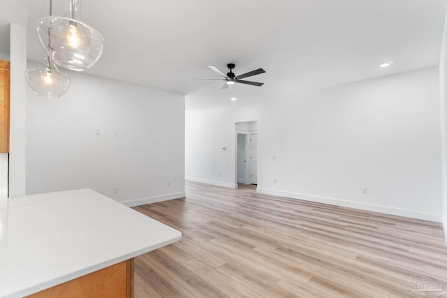 living room with light hardwood / wood-style flooring and ceiling fan