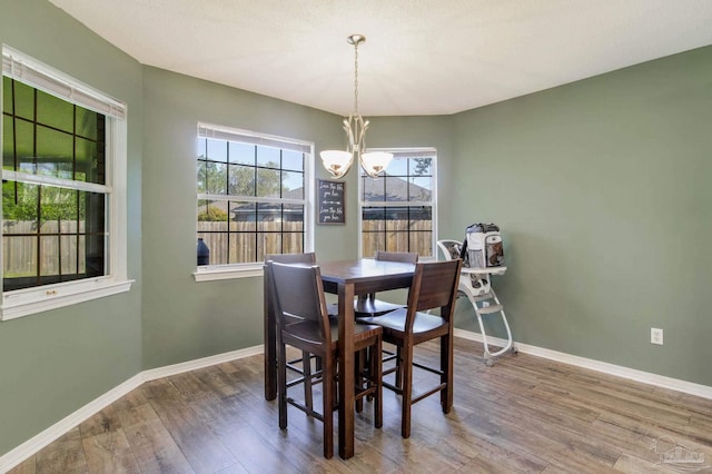 dining room with a notable chandelier and hardwood / wood-style floors