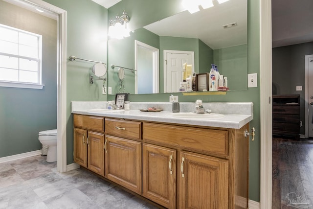 bathroom featuring vanity, hardwood / wood-style flooring, and toilet