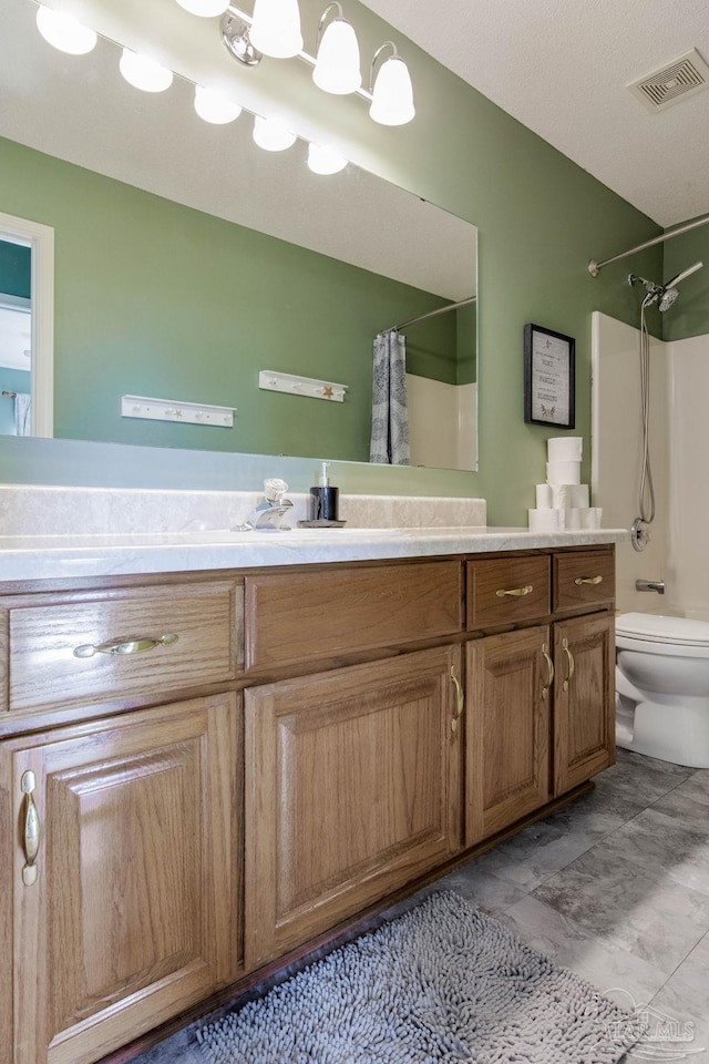 bathroom with vanity, toilet, and walk in shower