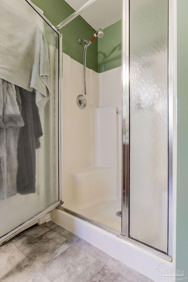 bathroom with a shower with shower door