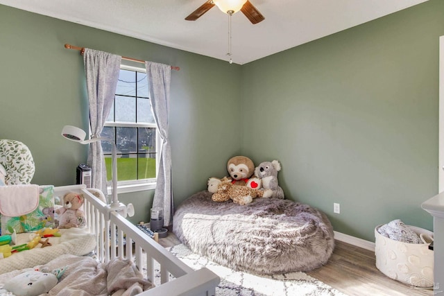 bedroom with hardwood / wood-style flooring and ceiling fan