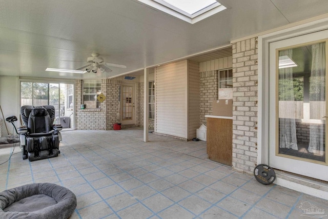 exterior space with a skylight and ceiling fan