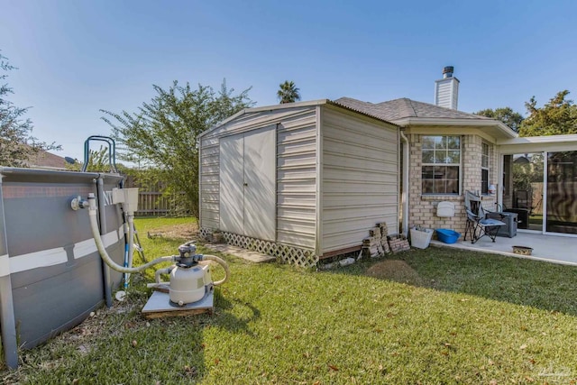 view of outbuilding featuring a yard