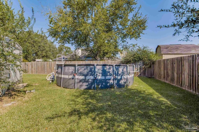 view of yard with a fenced in pool