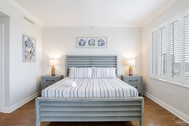 bedroom featuring ornamental molding, wood finished floors, and baseboards