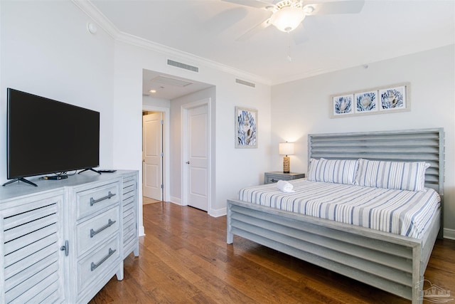 bedroom featuring visible vents, crown molding, and wood finished floors