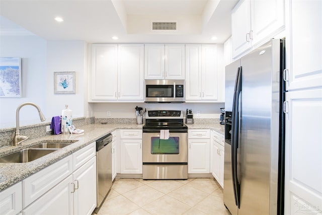 kitchen with light tile patterned floors, visible vents, appliances with stainless steel finishes, white cabinets, and a sink