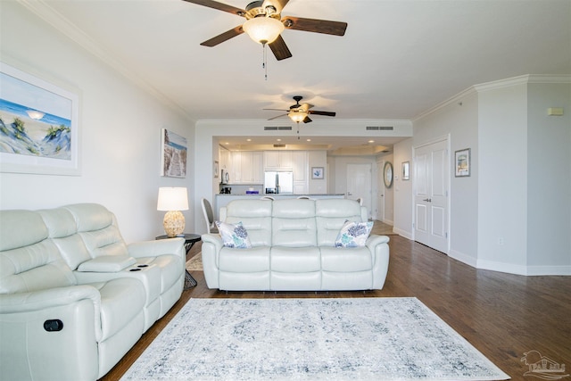 living room featuring dark wood-type flooring, visible vents, and ornamental molding