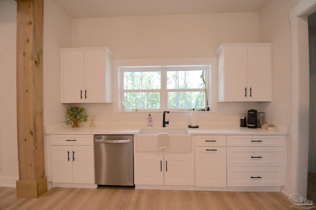 kitchen featuring light hardwood / wood-style flooring, sink, stainless steel dishwasher, and white cabinetry