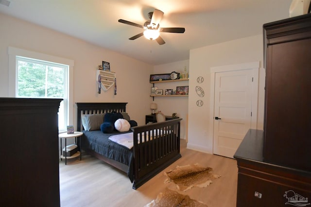 bedroom with light wood-type flooring and ceiling fan