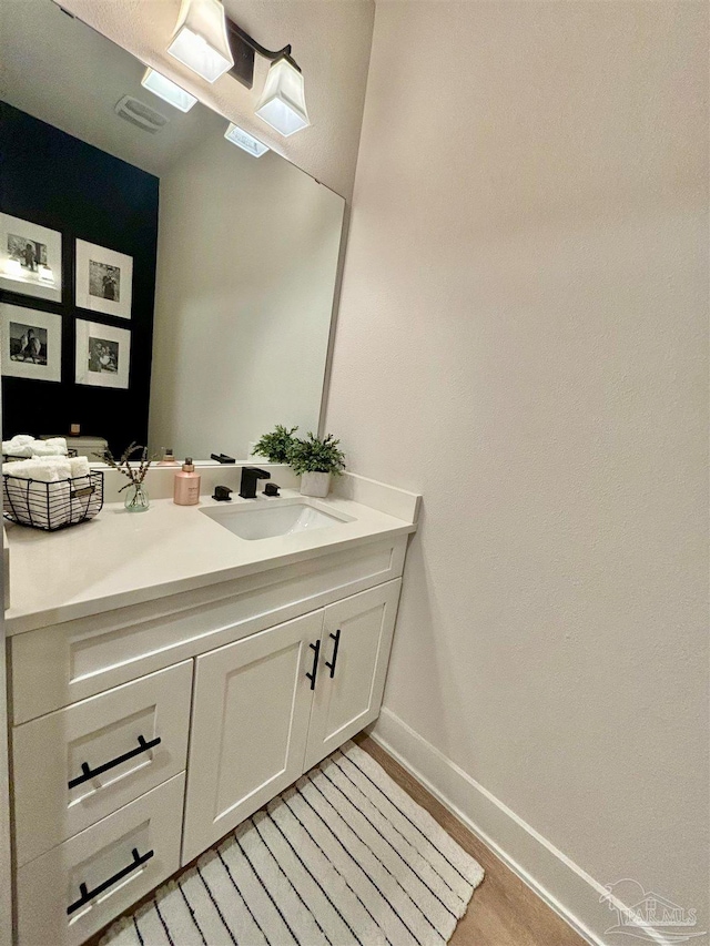 bathroom featuring vanity and hardwood / wood-style flooring