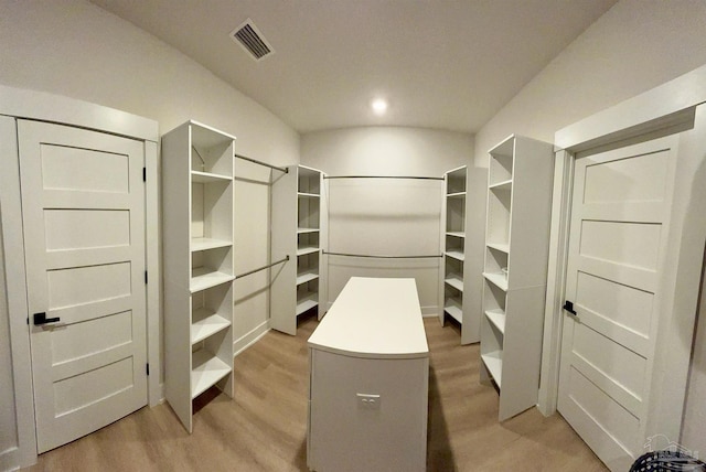 spacious closet featuring light hardwood / wood-style flooring