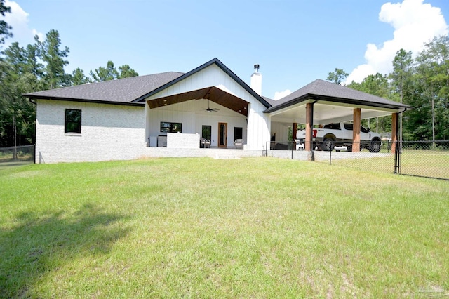 back of house featuring ceiling fan and a lawn