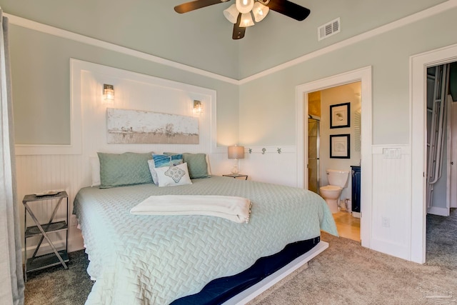 bedroom featuring connected bathroom, carpet flooring, and ceiling fan