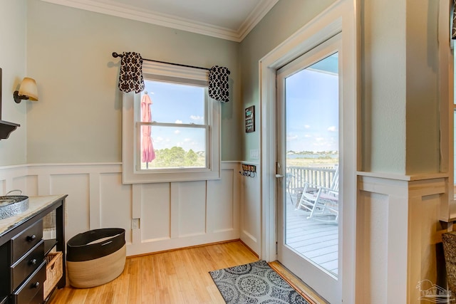 entryway featuring light wood-type flooring and ornamental molding