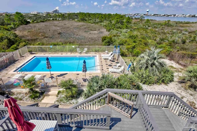 view of swimming pool with a deck with water view