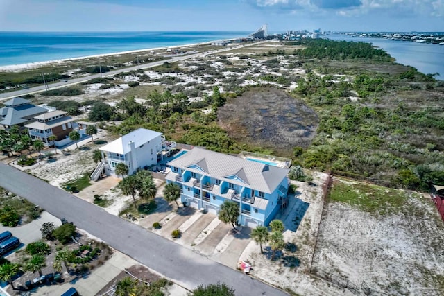 bird's eye view featuring a water view and a beach view