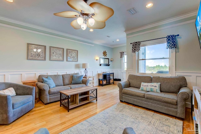 living room featuring ceiling fan, light hardwood / wood-style flooring, and crown molding