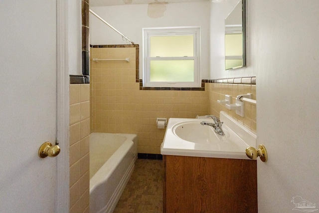 bathroom featuring vanity and tile walls