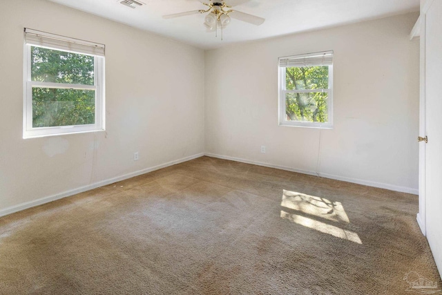 carpeted empty room featuring ceiling fan