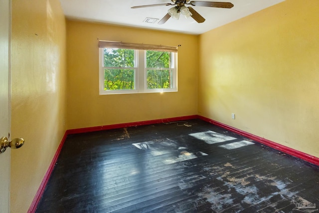 unfurnished room with dark hardwood / wood-style flooring and ceiling fan