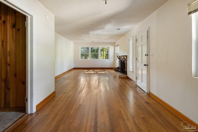 unfurnished living room featuring hardwood / wood-style floors