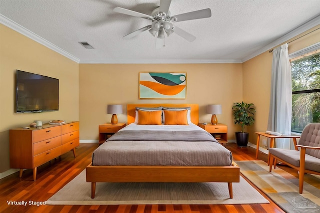 bedroom with crown molding, ceiling fan, hardwood / wood-style floors, and a textured ceiling