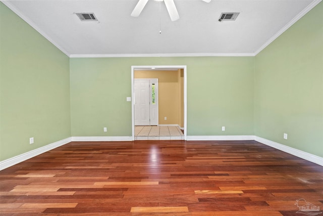 empty room featuring crown molding, hardwood / wood-style floors, and ceiling fan