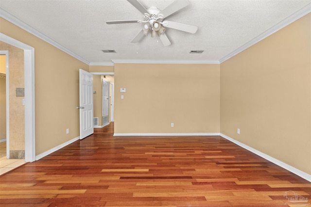 spare room featuring ceiling fan, hardwood / wood-style flooring, ornamental molding, and a textured ceiling