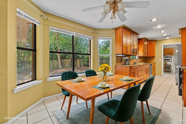 tiled dining room with sink and ceiling fan