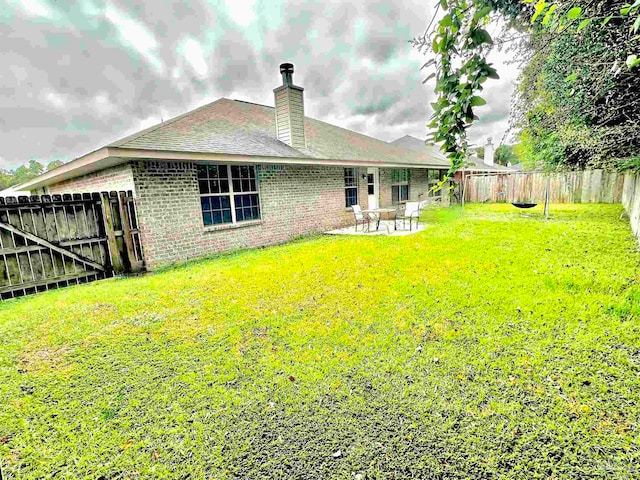 exterior space with a lawn and a patio